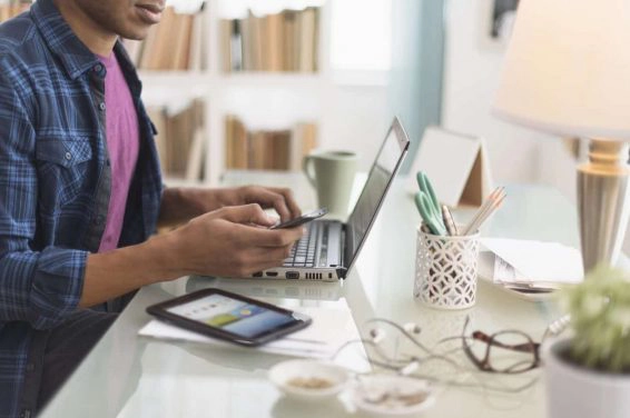 Black businessman multi tasking at desk