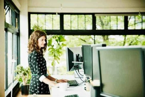 Female engineer coding in small high tech office