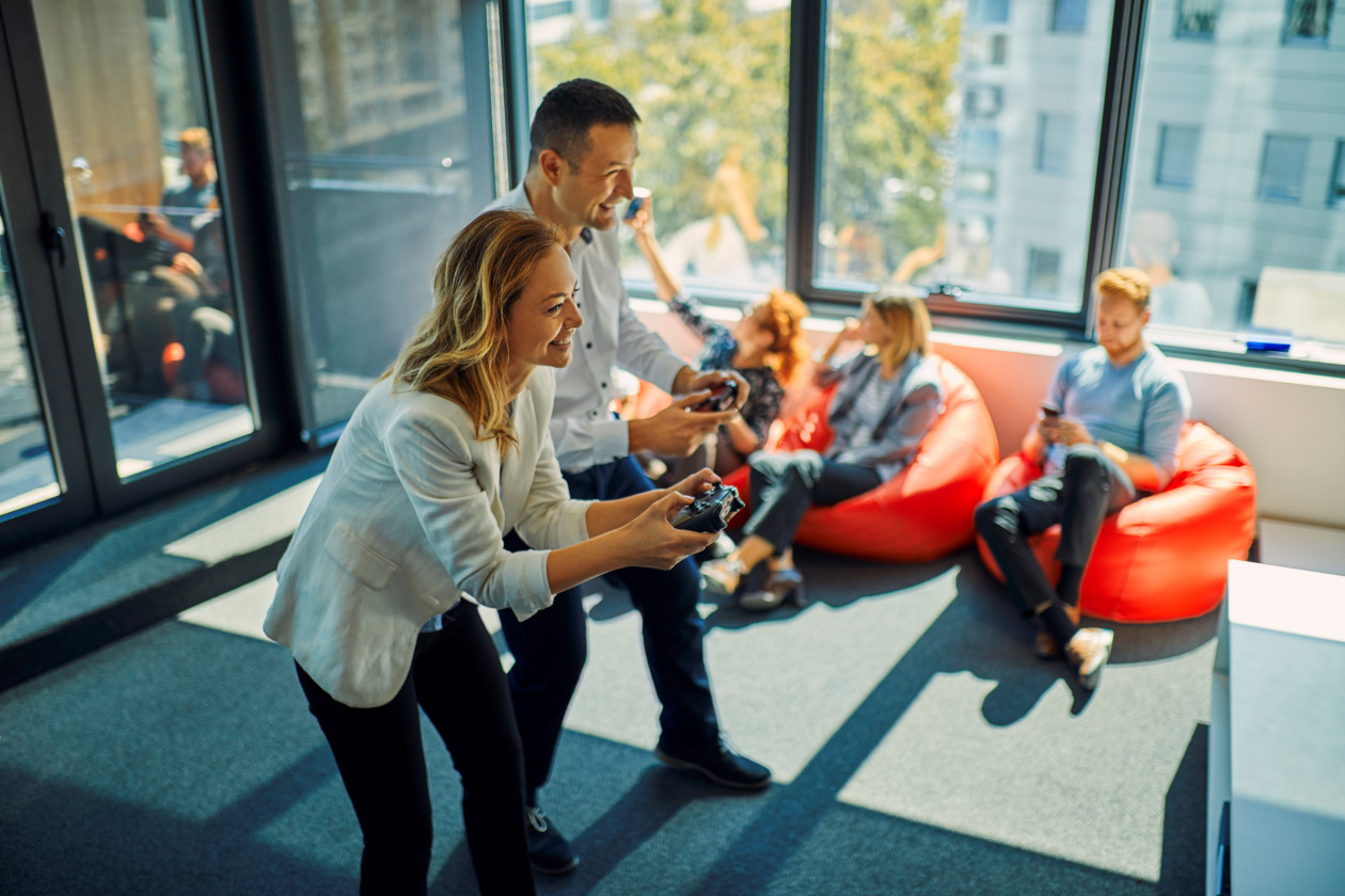 Colleagues playing video game in office