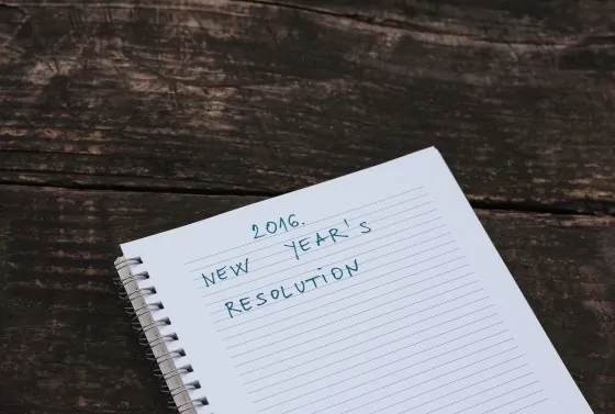 2016. new year’s resolution written in a notebook