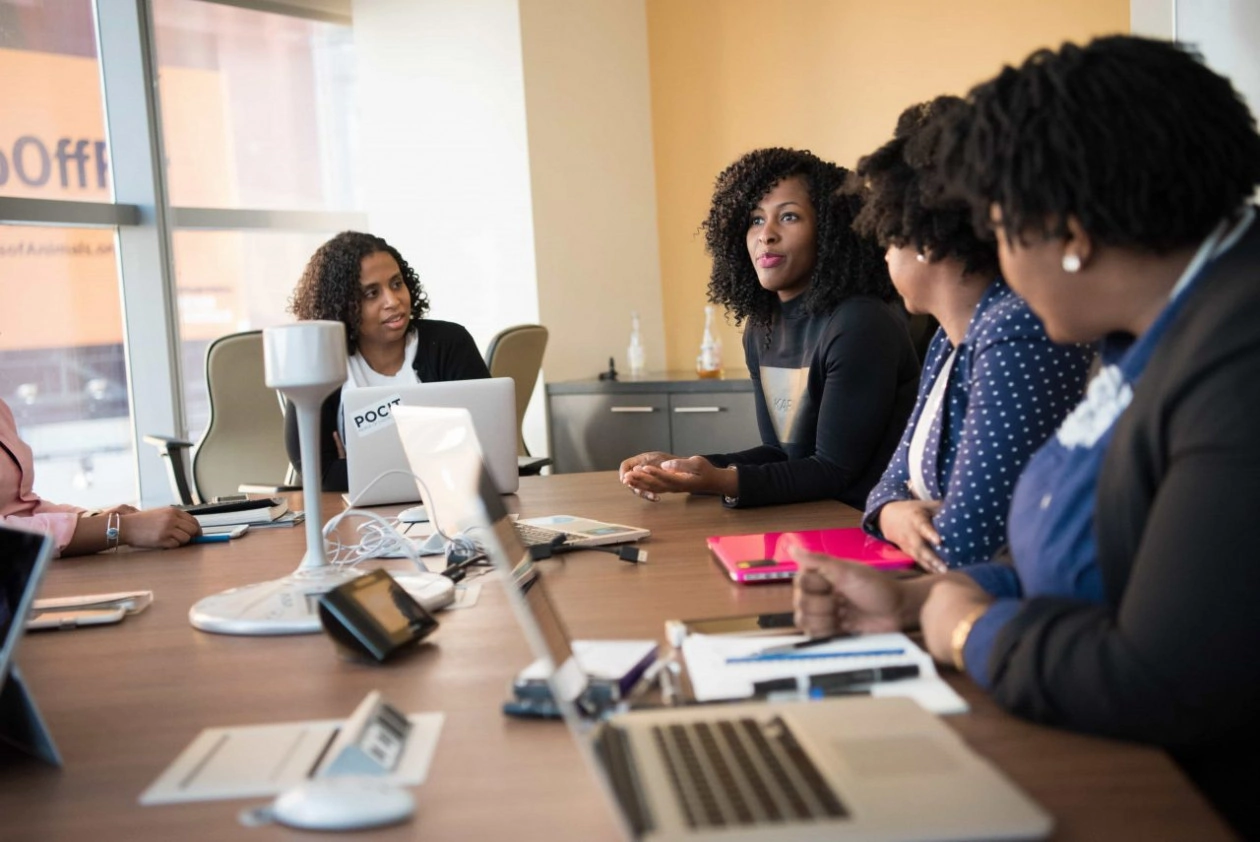 Canva   four woman at the conference room