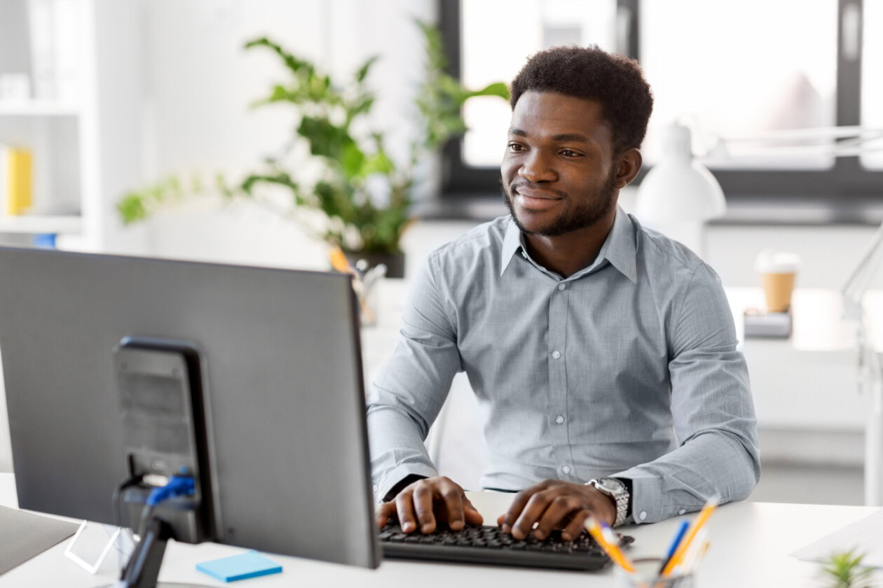 African businessman with computer at office