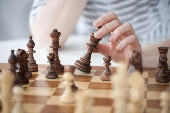 Woman’s hands playing chess