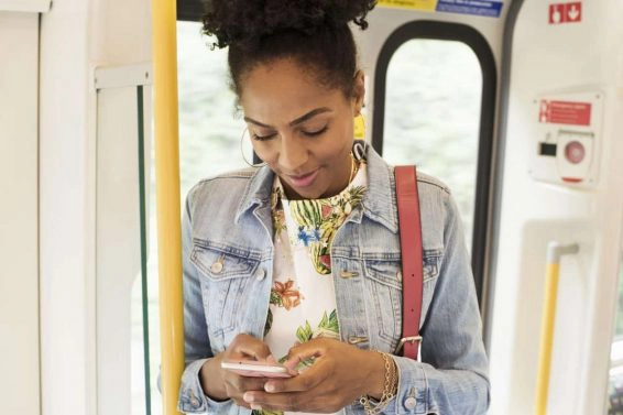 Woman using her phone on a train