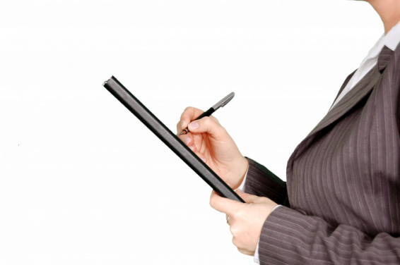 Canva   woman in gray pinstripe blazer holding black and gray stylus pen and black pad
