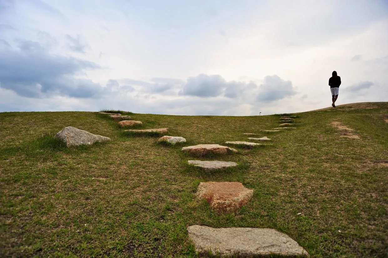 Man walking at top of forking rock