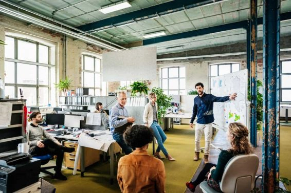 Office manager addressing his team during morning meeting
