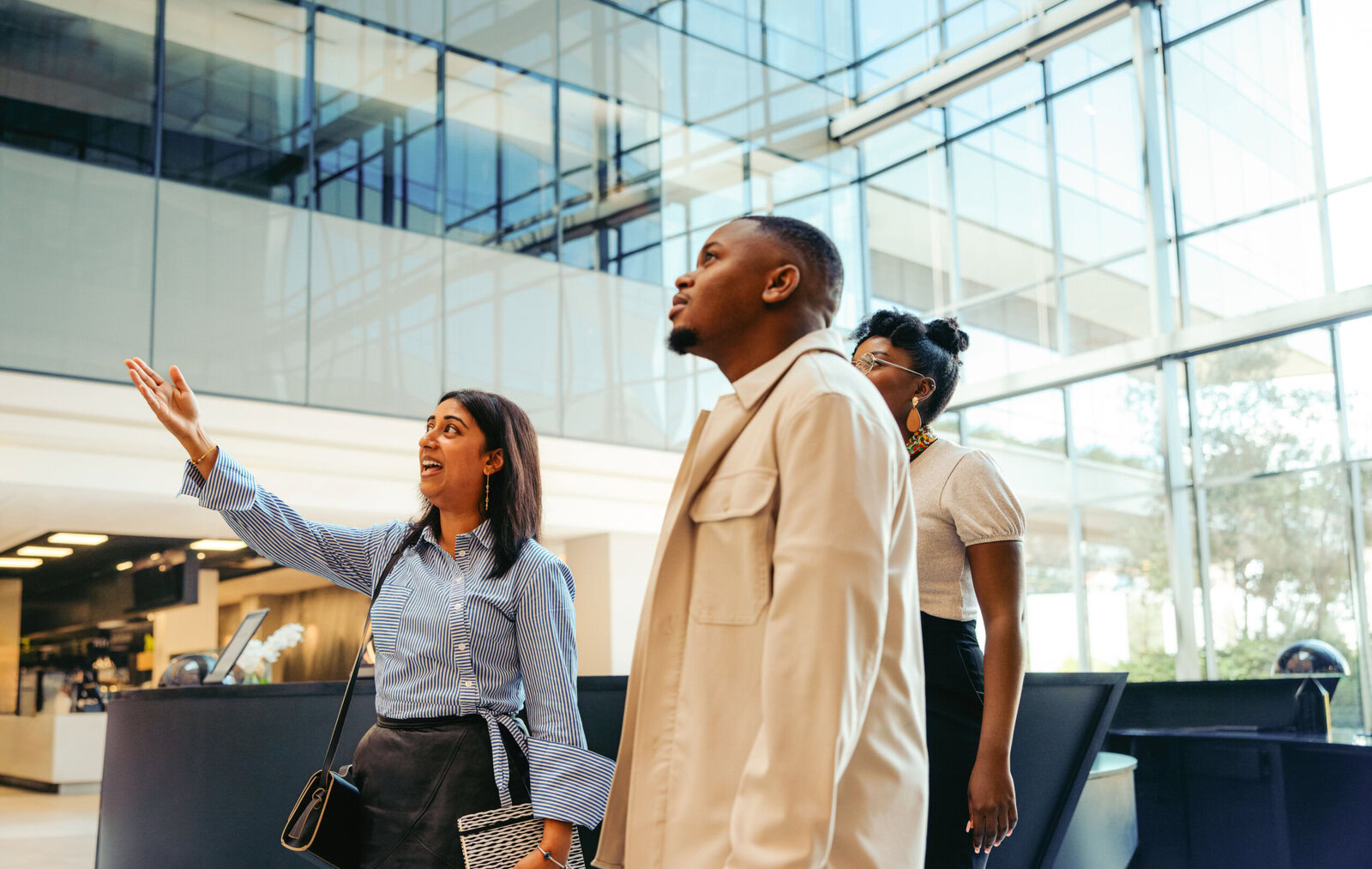Confident manager onboarding new recruits in a bright corporate office setting