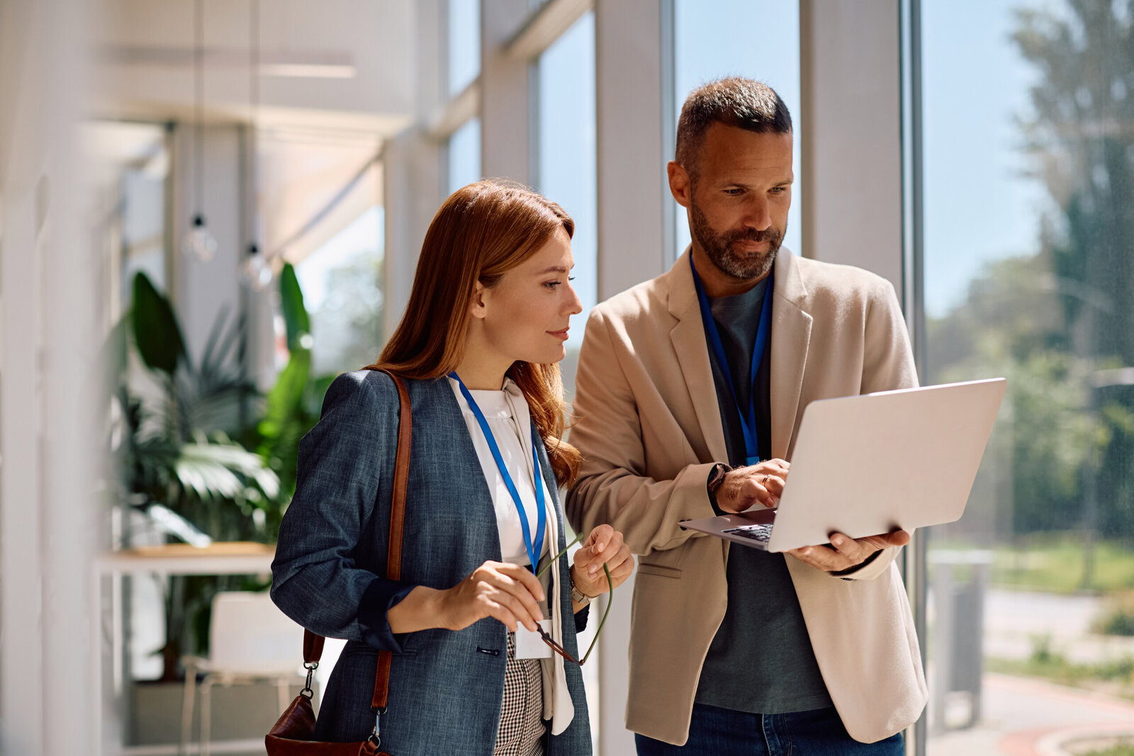 Business colleagues using laptop while working in the office.