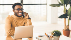 Black businessman talking on cell phone at office