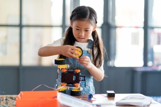 Young girl working on a robot design