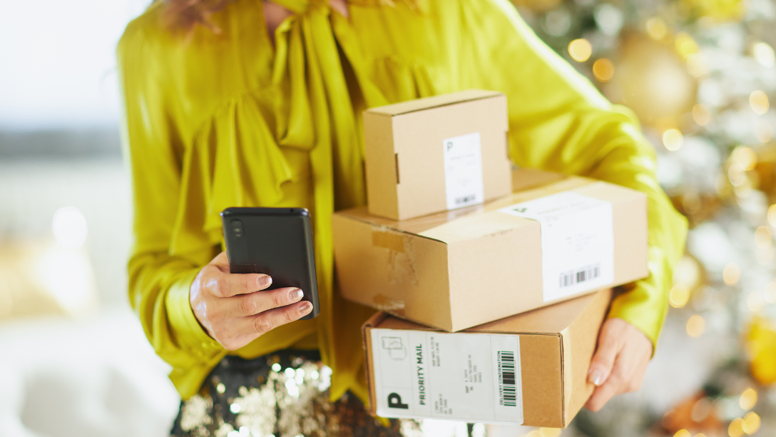 Close up of women with three small boxes with items she purchased online