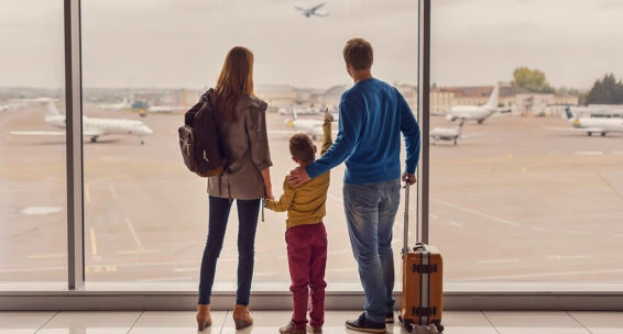 Family looking out window at airport