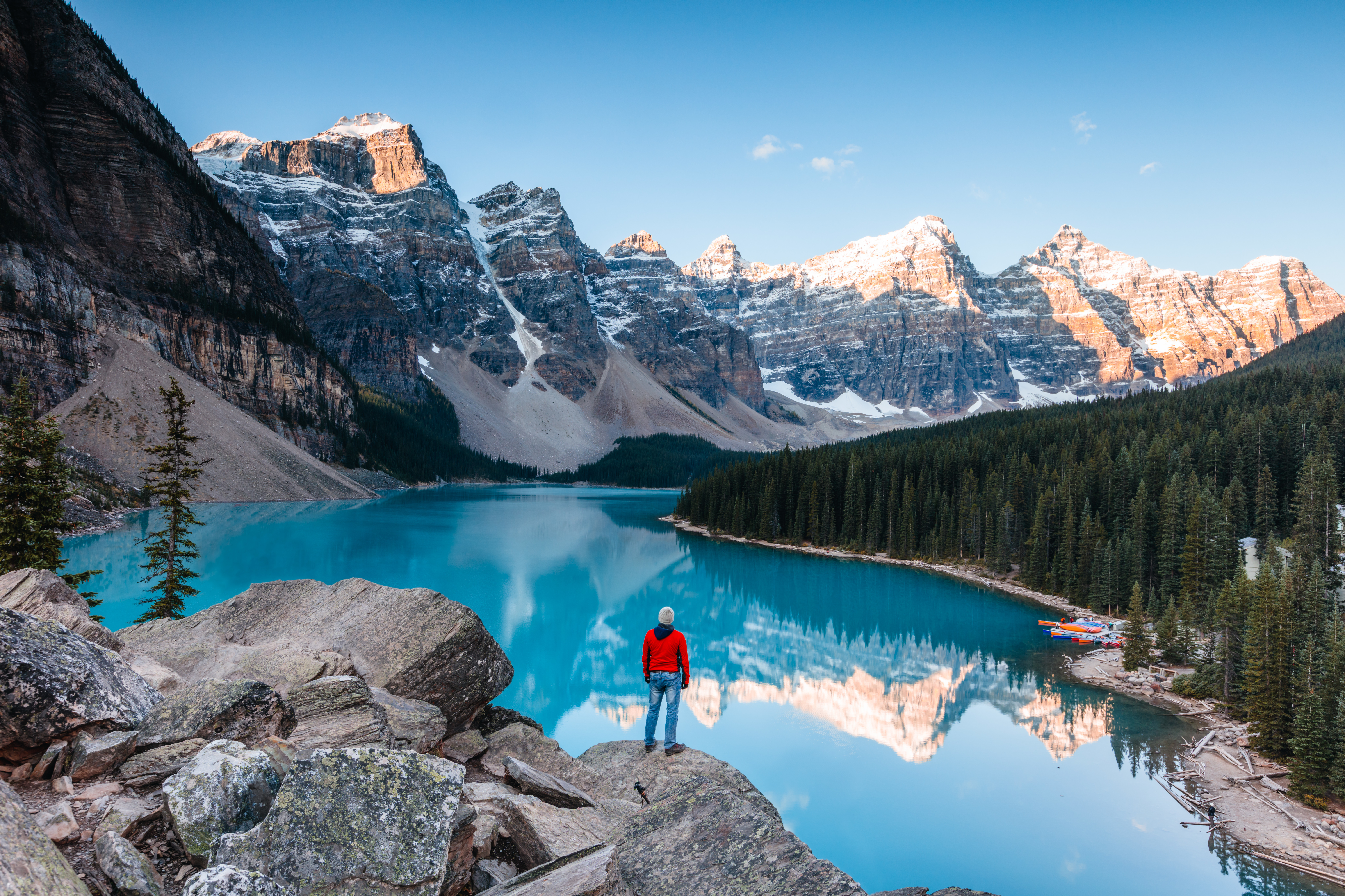 Man at moraine lake at sunrise, banff, canada
