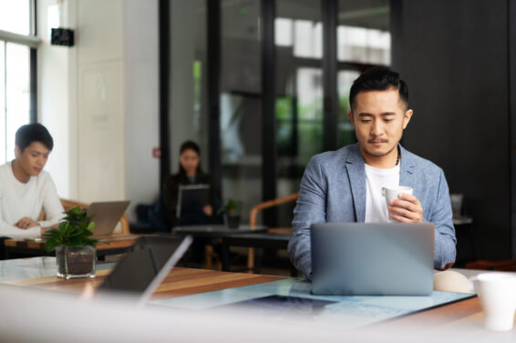 Young chinese business people working with laptop