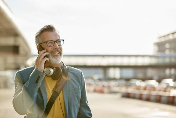Mature businessman talking on mobile phone in city