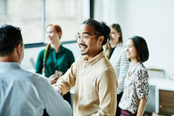 Businessman shaking hands with colleague after meeting in office