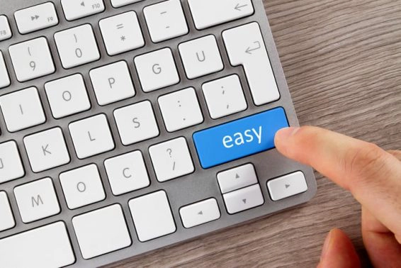 Human finger is pushing easy button on computer keyboard