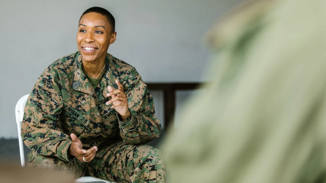 Female veteran talking to a colleague who's just out of focus
