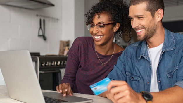 Happy couple banking online together