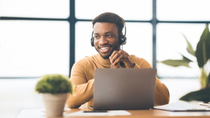 Happy afro manager working in call centre