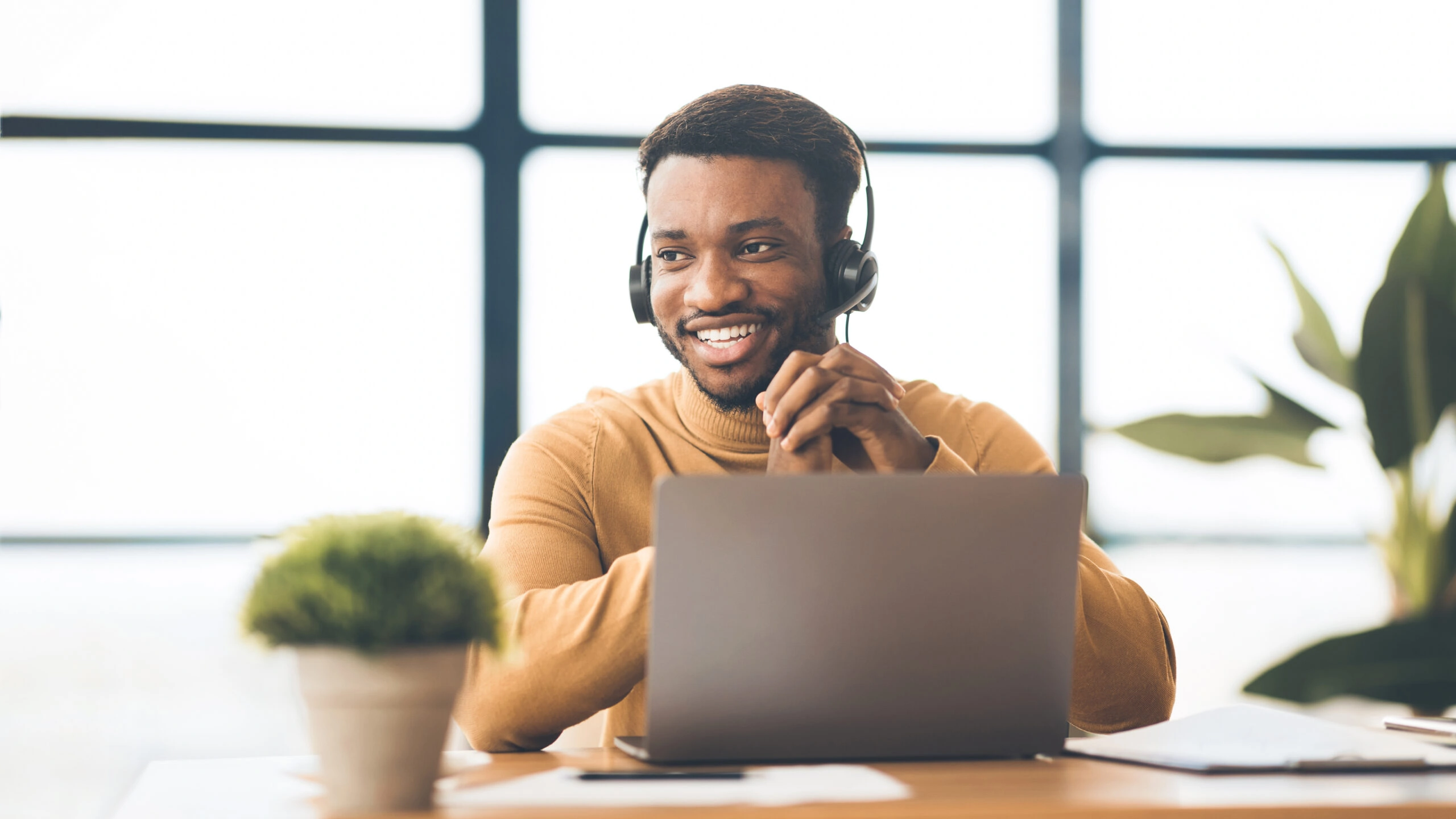 Happy afro manager working in call centre