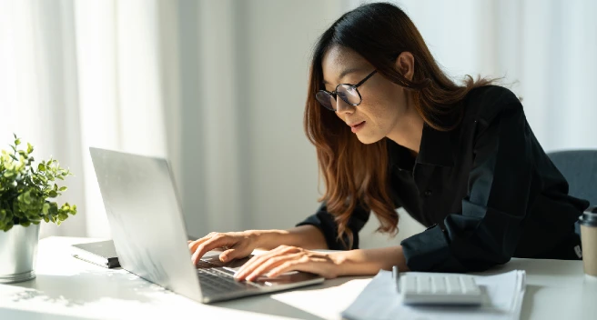 Woman doing financial work on her laptop
