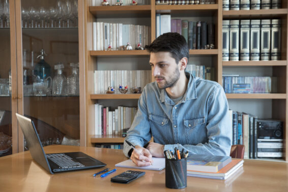 Young male studying for university at home via online lessons during the coronavirus quarantine. distance education