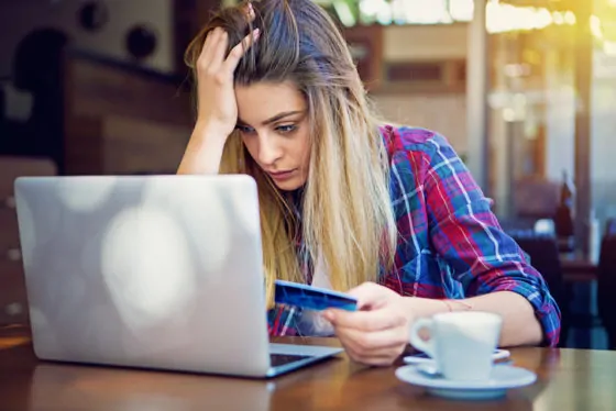 Young girl have problems with her credit card till shopping online