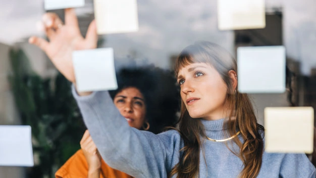 Women brainstorming using sticky notes
