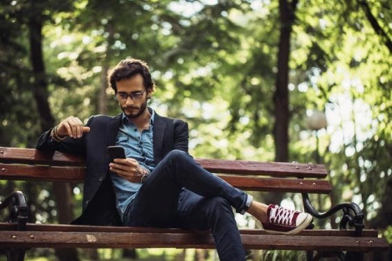 Man texting in park