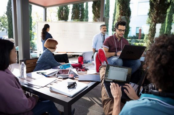 Hackers using laptops at hackathon