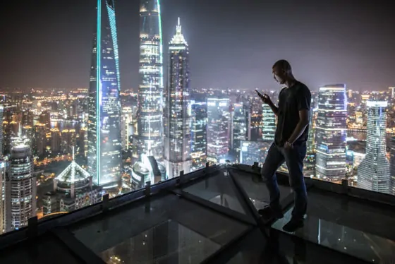 Portrait of young man watching smart phone on the roof