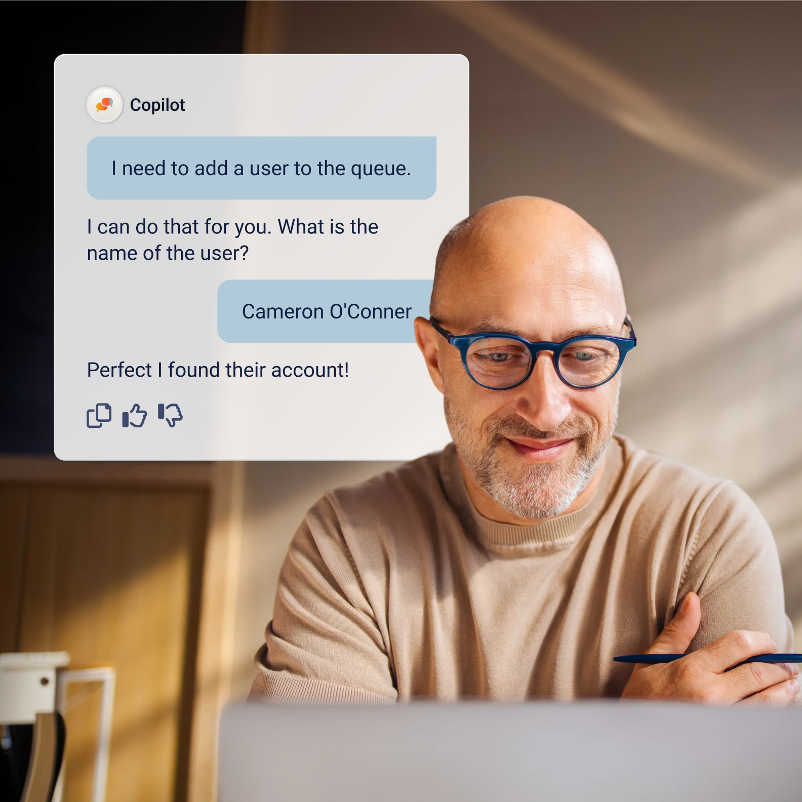 Man wearing glasses working at a desk, with a copilot chat panel showing an agent adding a user named cameron o'connor to a queue.