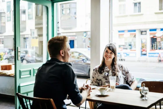 Young couple taking a break together for drink in cafe